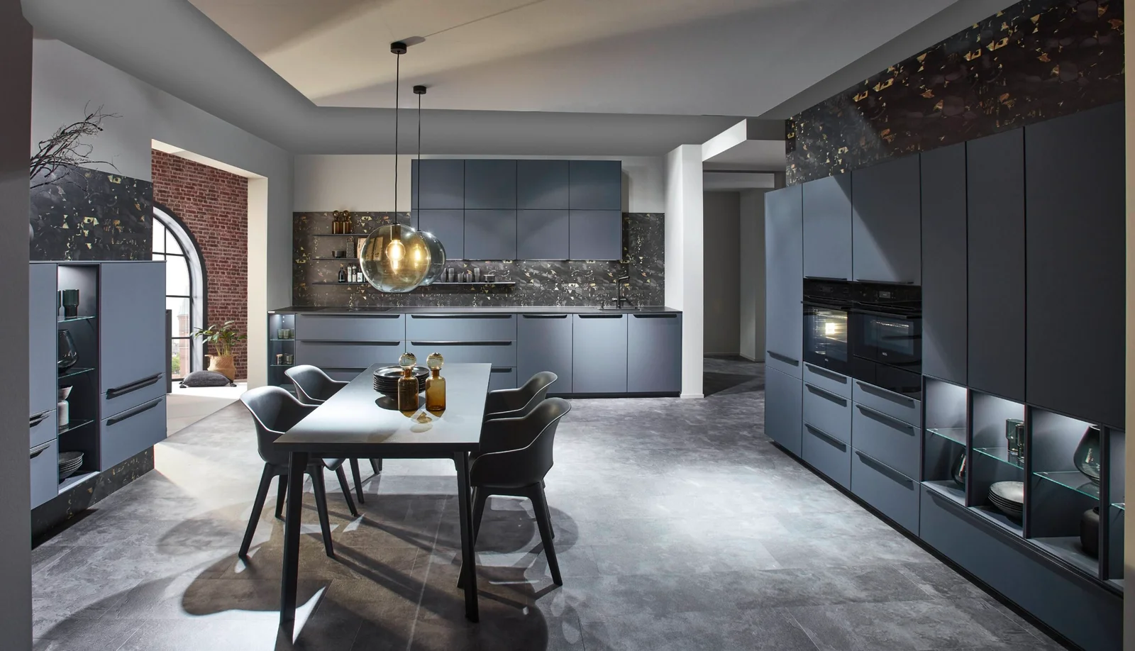 High-end European kitchen with slate blue frameless cabinets and marble backsplash